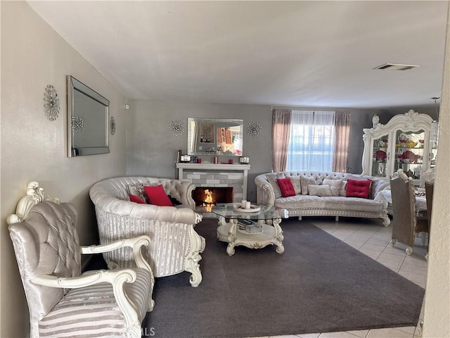 living room with light tile patterned floors and a fireplace