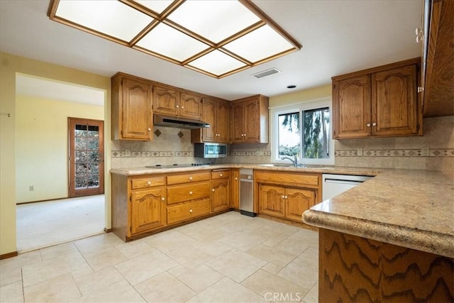 kitchen with light countertops, brown cabinetry, and white dishwasher