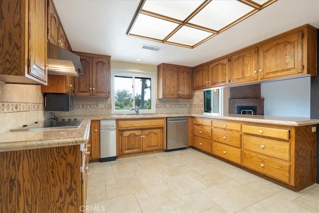 kitchen featuring under cabinet range hood, brown cabinets, light countertops, and dishwasher