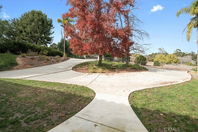 surrounding community featuring a lawn and fence