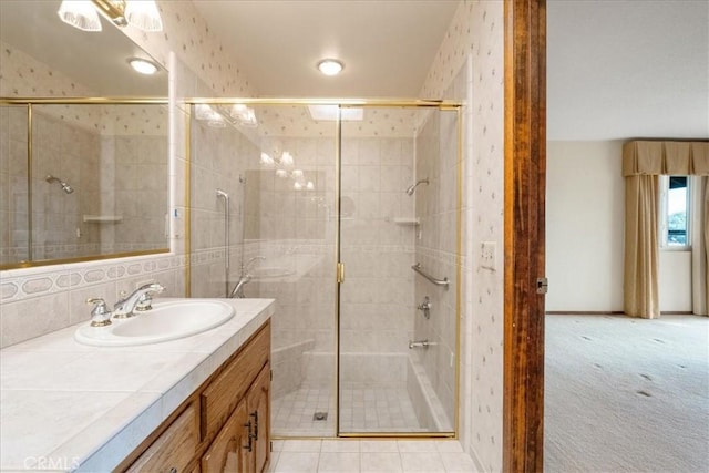 bathroom with a shower stall and vanity