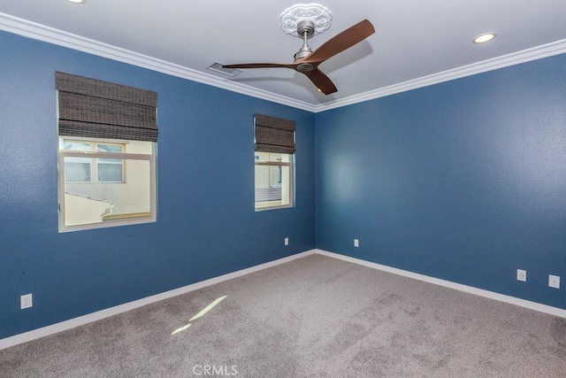 empty room with ornamental molding, carpet floors, and ceiling fan