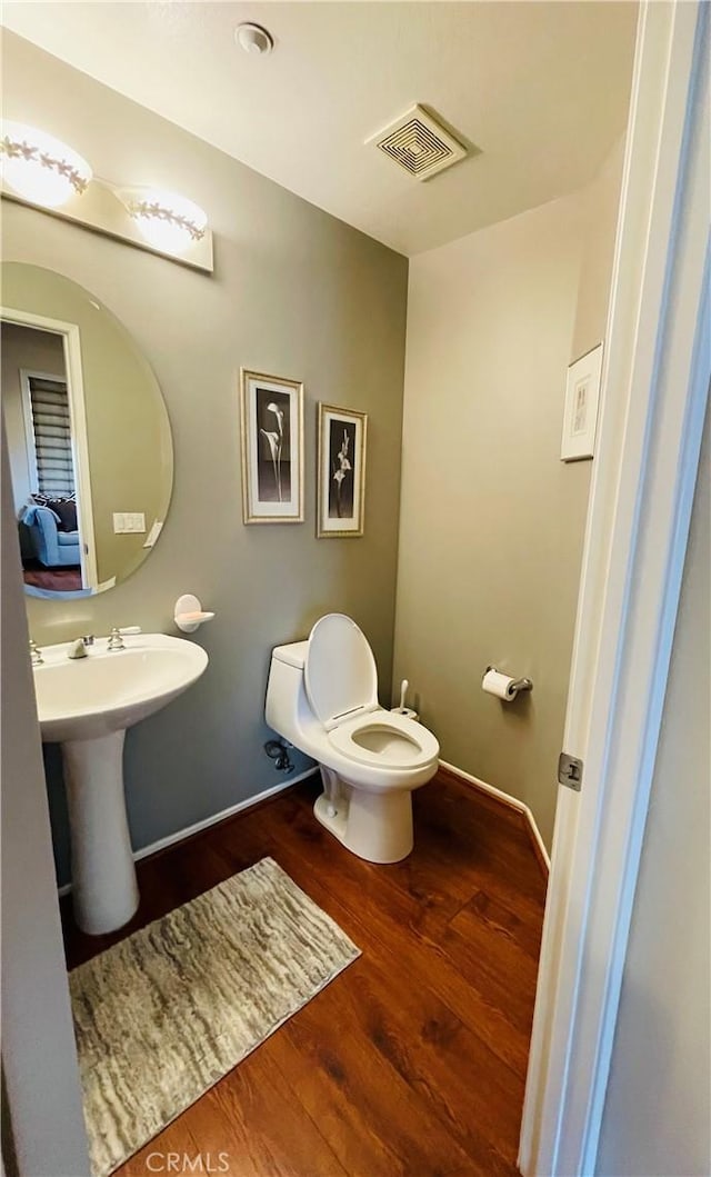 bathroom featuring hardwood / wood-style floors, sink, and toilet