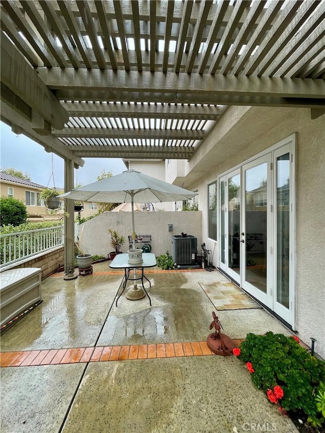 view of patio / terrace featuring french doors, central AC, and a pergola