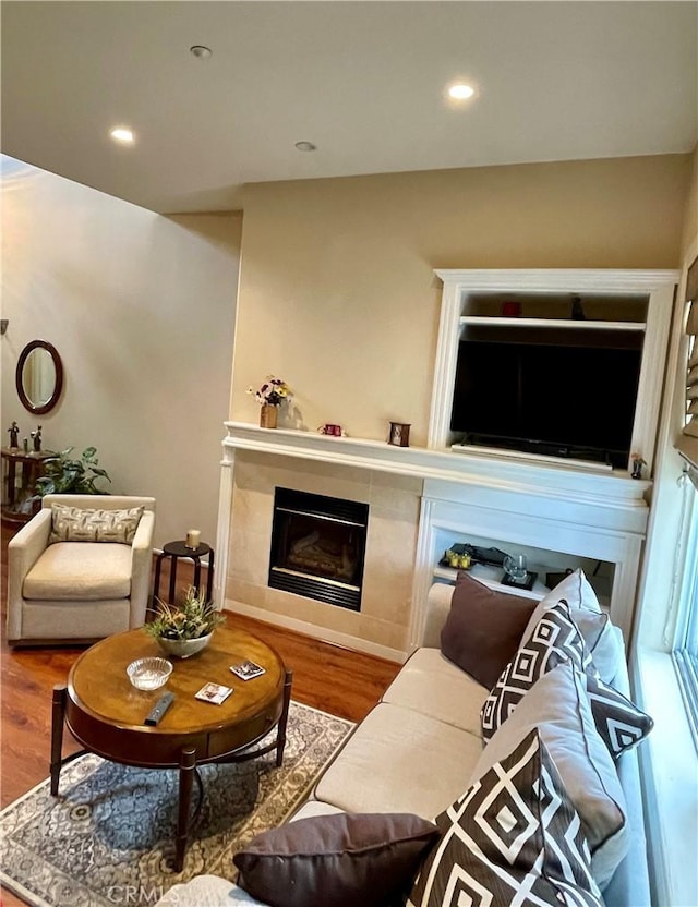 living room featuring hardwood / wood-style flooring and a fireplace