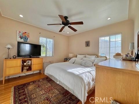 bedroom with ceiling fan and hardwood / wood-style floors