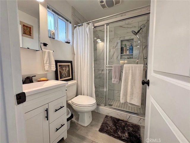 bathroom featuring vanity, toilet, and a shower with shower curtain