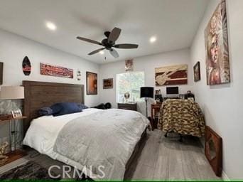 bedroom with wood-type flooring and ceiling fan