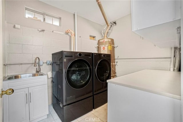 laundry room with separate washer and dryer, sink, light tile patterned floors, and cabinets