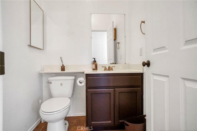 bathroom with vanity, tile patterned flooring, and toilet