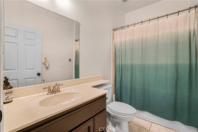 bathroom with tile patterned floors, vanity, and toilet