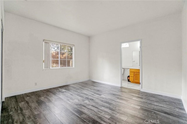 spare room with hardwood / wood-style floors