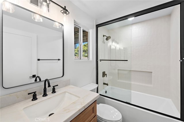 full bathroom with bath / shower combo with glass door, vanity, and toilet