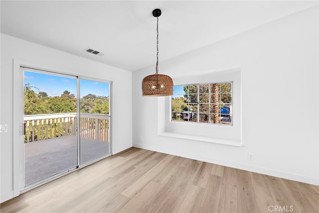 unfurnished dining area featuring a healthy amount of sunlight and light hardwood / wood-style flooring