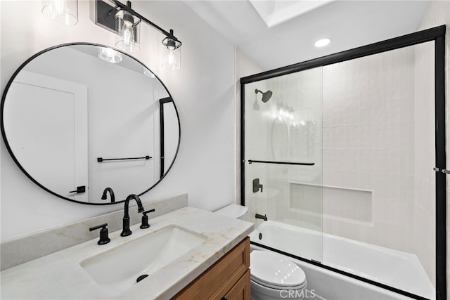 full bathroom with vanity, shower / bath combination with glass door, and toilet