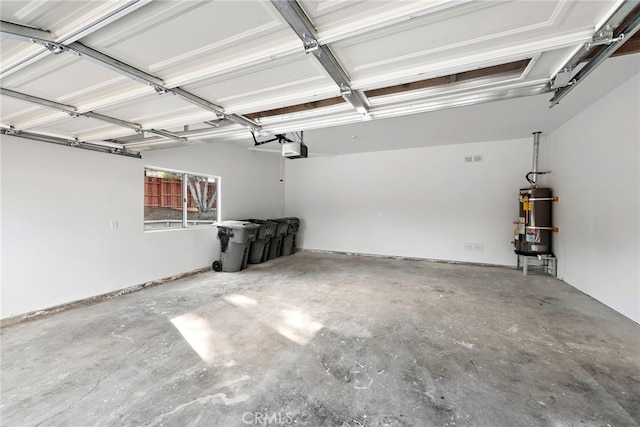 garage featuring strapped water heater and a garage door opener