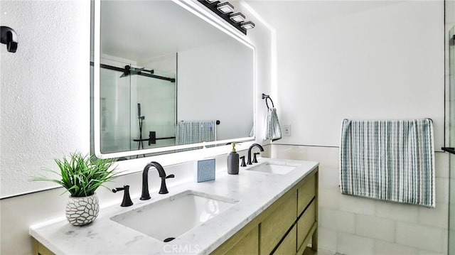 bathroom featuring vanity and an enclosed shower