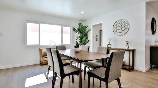 dining space with light hardwood / wood-style flooring