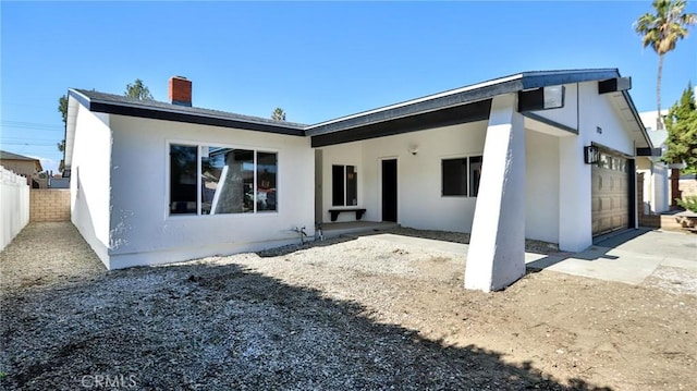 back of house featuring a garage