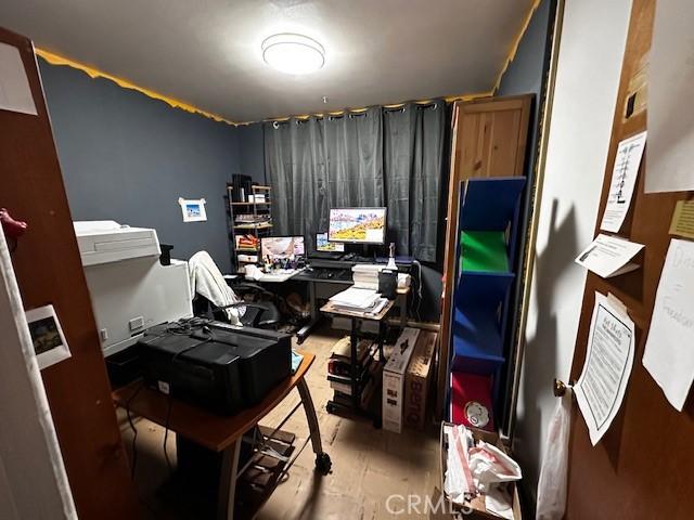 home office with light hardwood / wood-style flooring