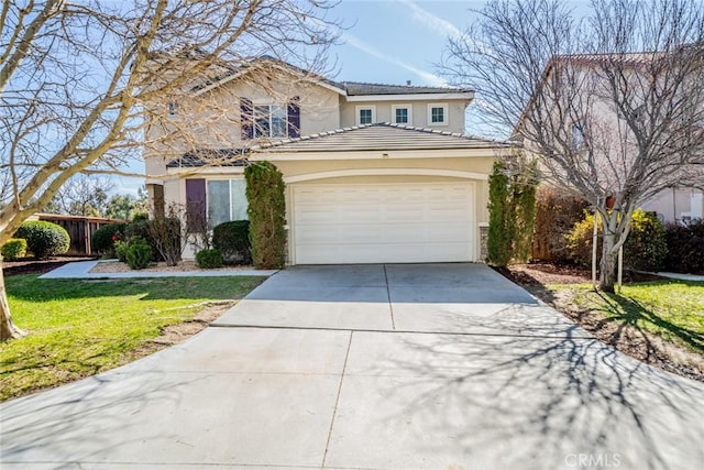 traditional-style home featuring an attached garage, a front lawn, a tile roof, stucco siding, and driveway