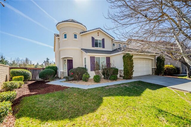 mediterranean / spanish-style home featuring a front yard, fence, concrete driveway, and stucco siding