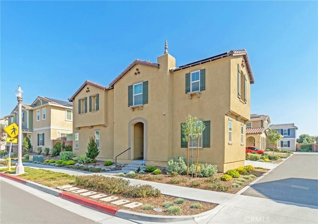 view of front of property with a residential view and stucco siding