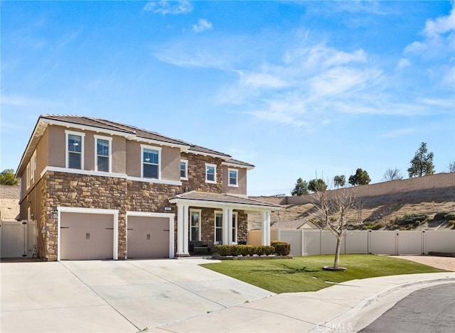 view of front of home with a garage and a front lawn