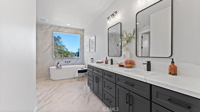 bathroom with vanity and a washtub