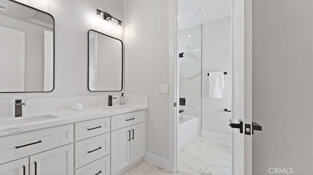 bathroom featuring washtub / shower combination and vanity