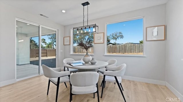 dining space with light hardwood / wood-style flooring