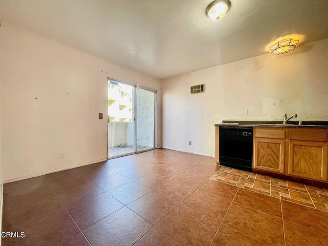 kitchen with tile patterned floors, dishwasher, and sink