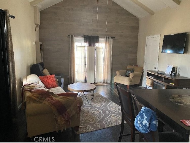 living area featuring high vaulted ceiling, beamed ceiling, and wood finished floors