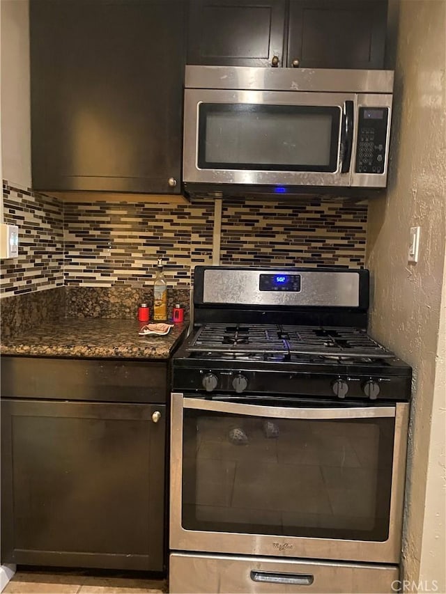 kitchen with tasteful backsplash, appliances with stainless steel finishes, and a textured wall