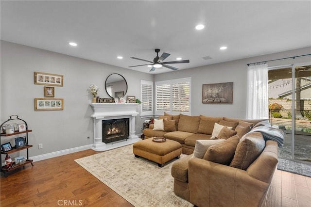 living room with hardwood / wood-style flooring and ceiling fan