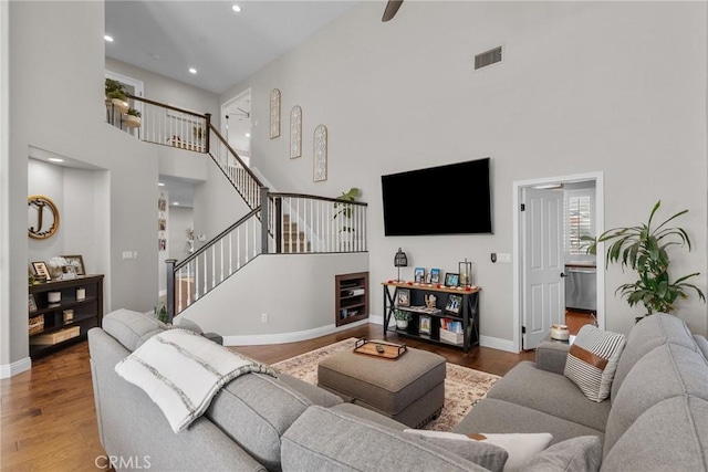 living room featuring hardwood / wood-style flooring and a high ceiling