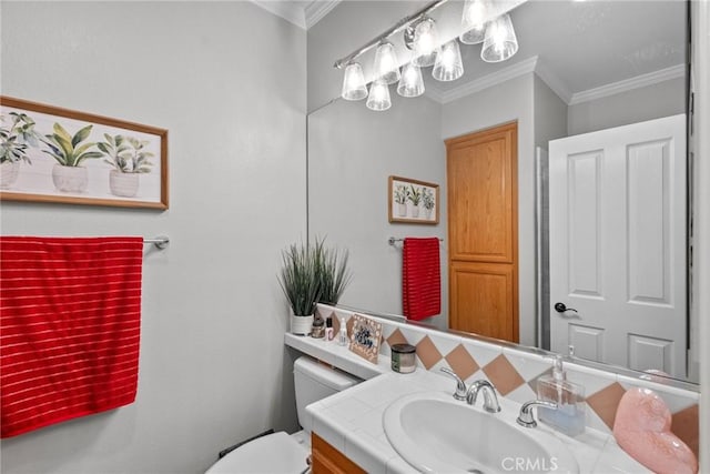 bathroom with crown molding, vanity, and toilet