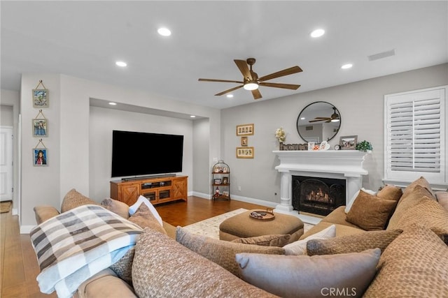 living room with wood-type flooring and ceiling fan