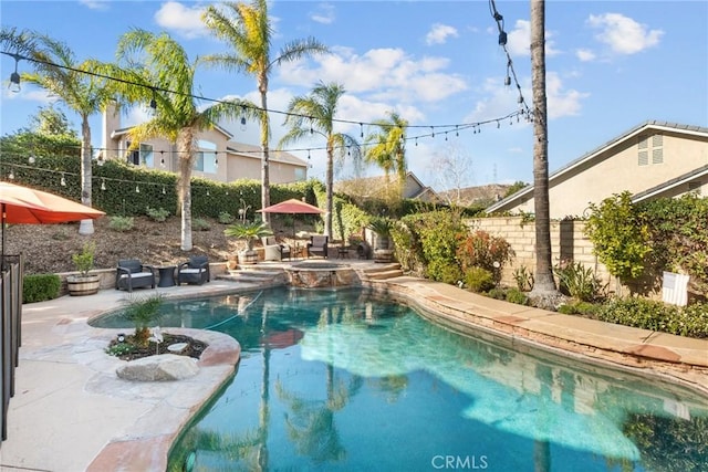 view of pool with a patio and an in ground hot tub