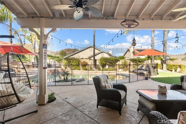 view of patio with ceiling fan and a fenced in pool