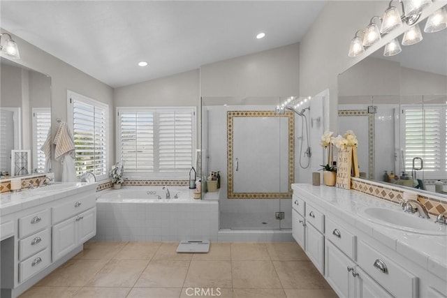 bathroom featuring tile patterned flooring, shower with separate bathtub, lofted ceiling, and vanity