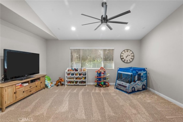 recreation room with ceiling fan, light colored carpet, and lofted ceiling