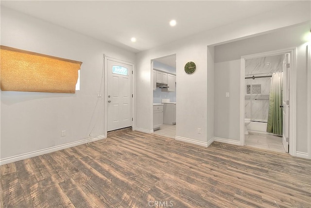 foyer entrance featuring baseboards, recessed lighting, and light wood-type flooring