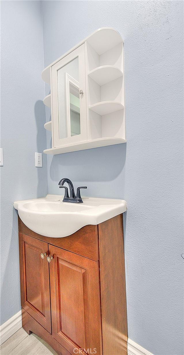 bathroom with baseboards and vanity