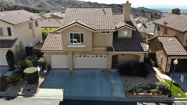 view of front of home featuring a garage and a mountain view