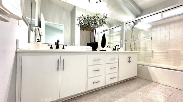 bathroom featuring vanity, tile patterned flooring, and combined bath / shower with glass door