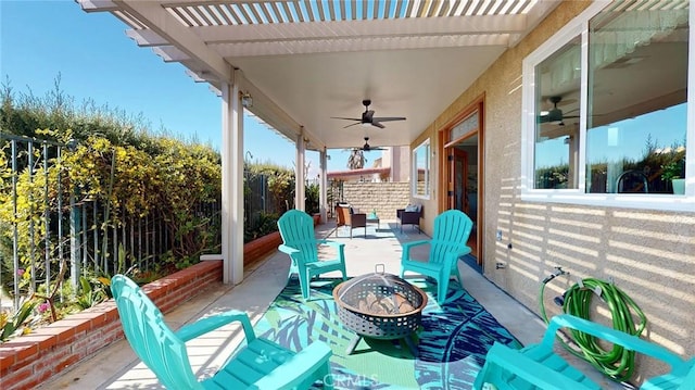 view of patio / terrace with a pergola, ceiling fan, and an outdoor fire pit