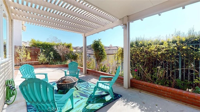 view of patio / terrace with a pergola and an outdoor fire pit