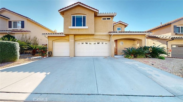 mediterranean / spanish-style house featuring a garage