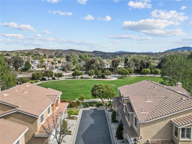 drone / aerial view featuring a residential view and a mountain view